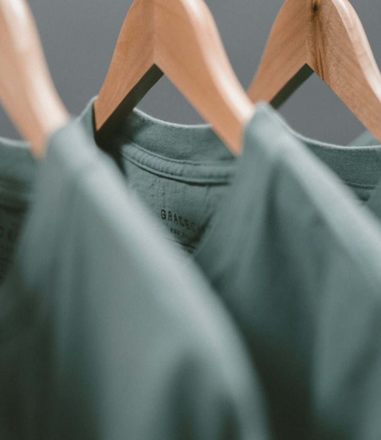 Naturally dyed garments on wooden hangers